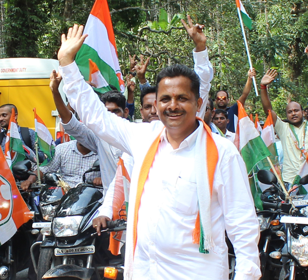 Udaya Shetty Muniyal greeting supporters at a rally in Karkala